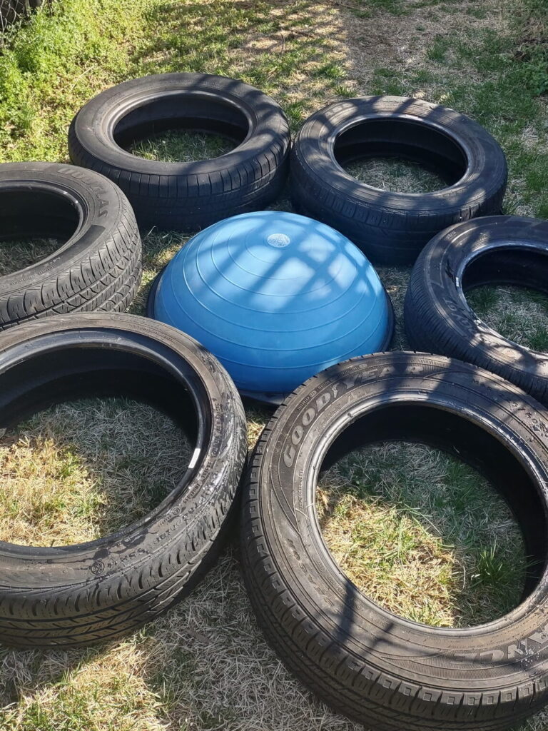 blue bosu ball surrounded by tires